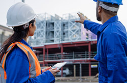 project manager going over construction details with the constructor of the building