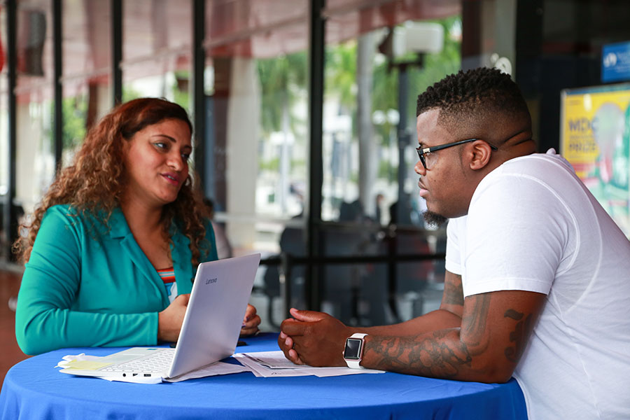 School of Business staff working with a MDC Students