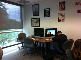 Student sitting in front of a computer at the Visual Resource Center